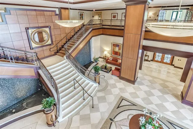 a view of a swimming pool with outdoor seating and city view