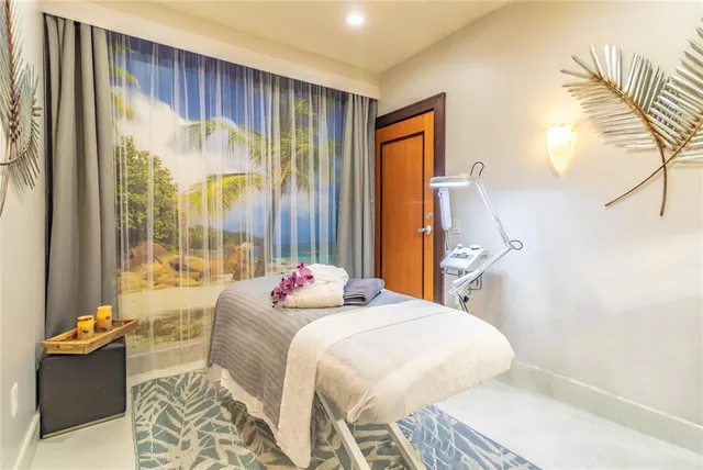 a living room with furniture large window and glass door