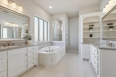a spacious bathroom with a double vanity sink mirror double and bathtub