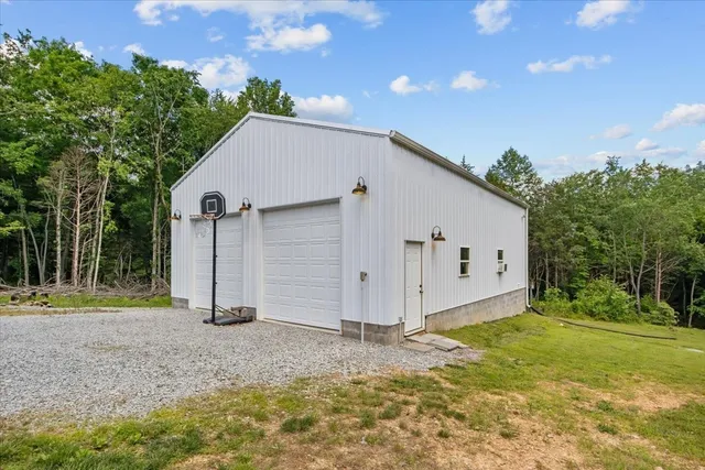 a view of a house with backyard and trees
