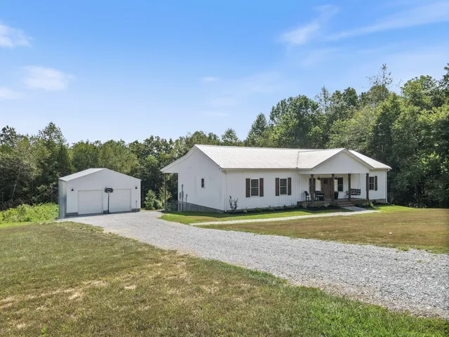 a front view of a house with a garden and yard