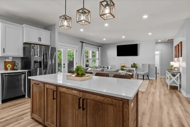 a kitchen with a sink appliances and cabinets