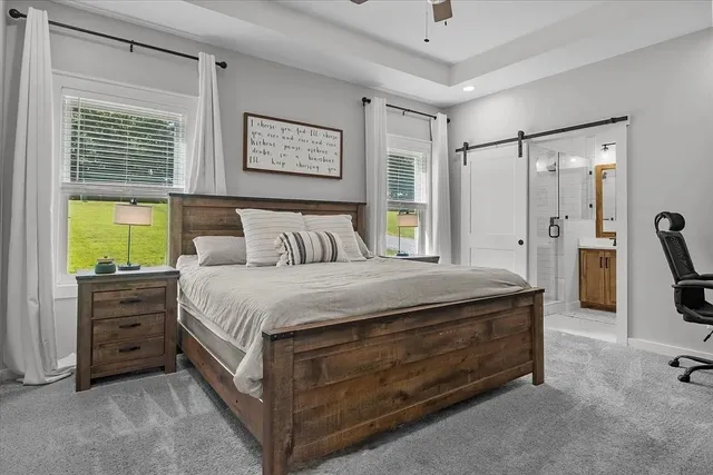 a spacious bedroom with a bed and a dresser
