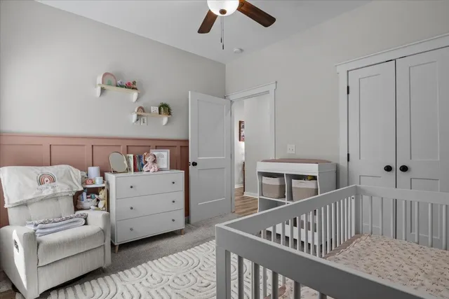 a bedroom with furniture and baby crib