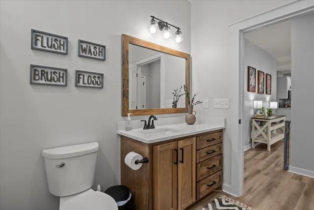 a bathroom with a toilet a sink and mirror