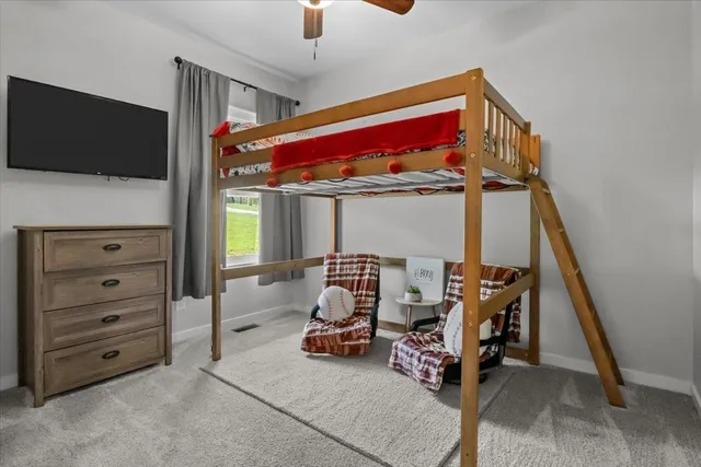 a bedroom with furniture and a flat screen tv