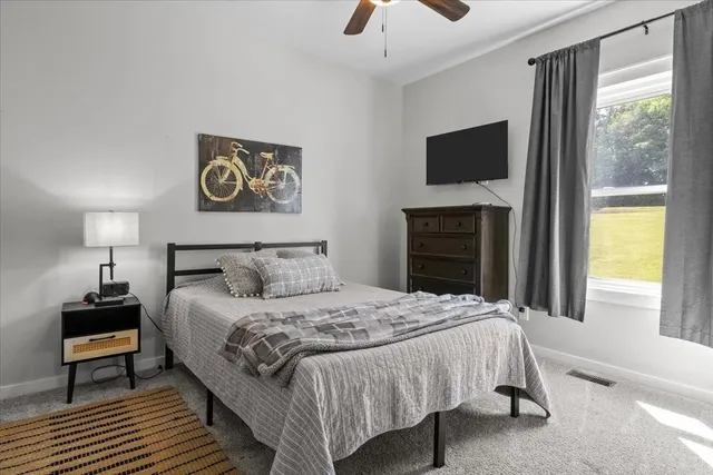 a bedroom with a bed and a flat tv screen