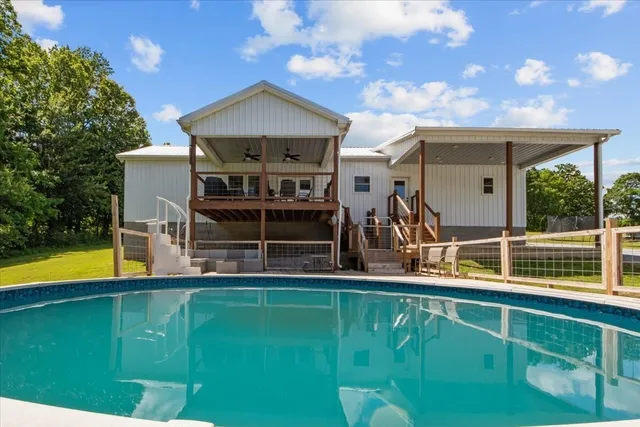 a view of a house with a backyard