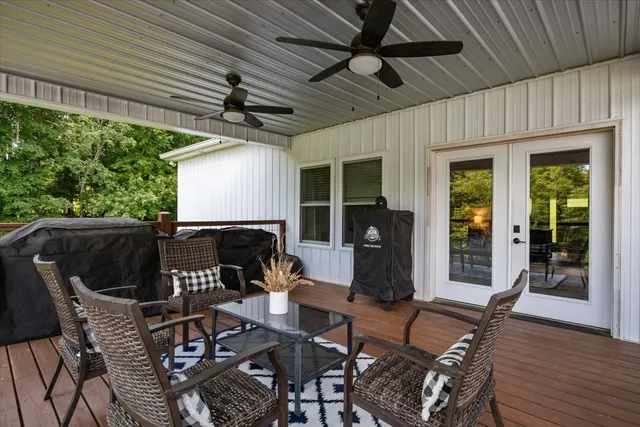 a patio table and chairs with potted plants