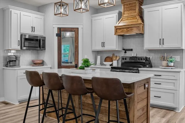 a kitchen with stainless steel appliances granite countertop a sink and cabinets