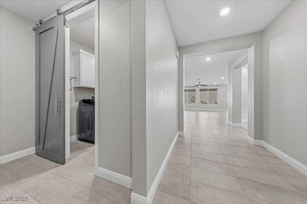 6479 Corsari Ridge Street Las Vegas, NV 89166 - Photo 18 of 38 Entry way looking to Laundry Room on Left and forward toward den, great room, wet bar, kitchen and dining space.