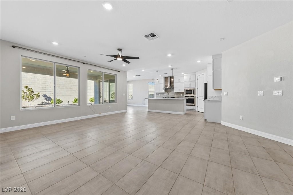 6479 Corsari Ridge Street Las Vegas, NV 89166 - Photo 10 of 38 Great room featuring wet bar, well appointed kitchen, and dining space next to sliding glass door.