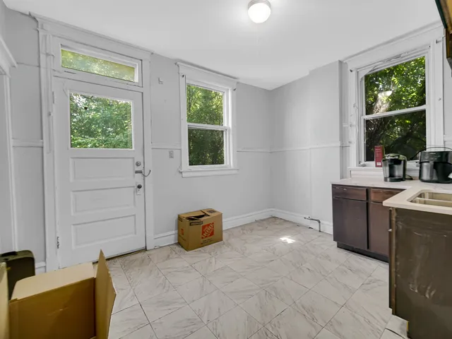 a view of a livingroom with furniture window and wooden floor