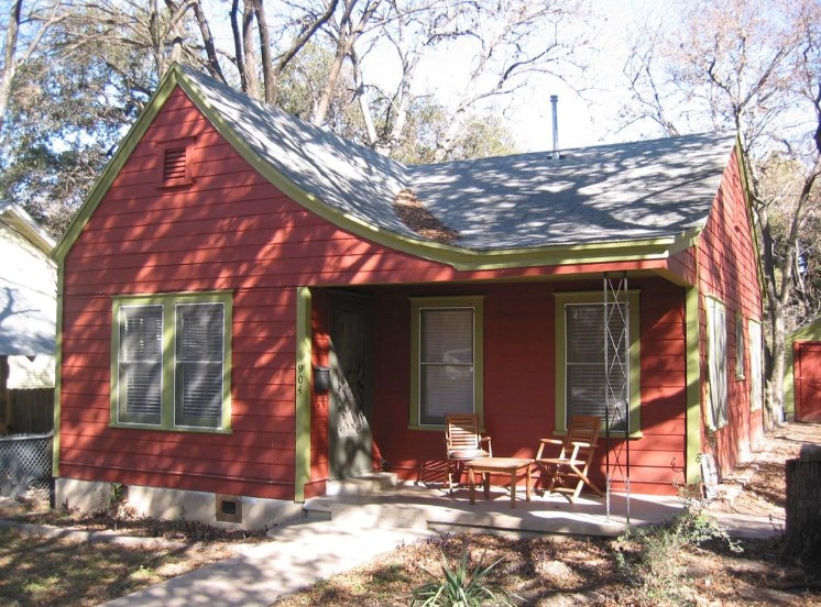 a view of a house with a yard and covered with snow