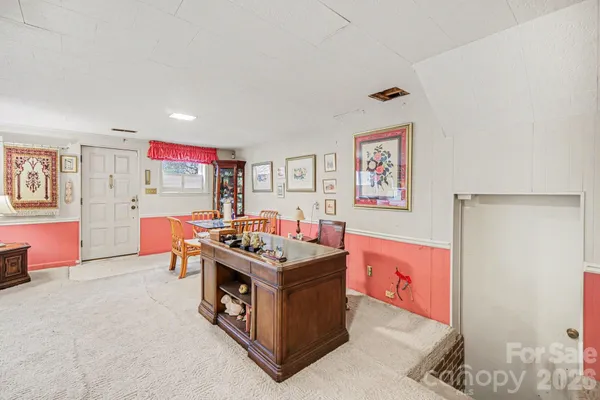 a view of kitchen with stainless steel appliances granite countertop a stove and a refrigerator