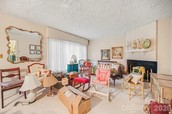 a living room with furniture a rug and a table
