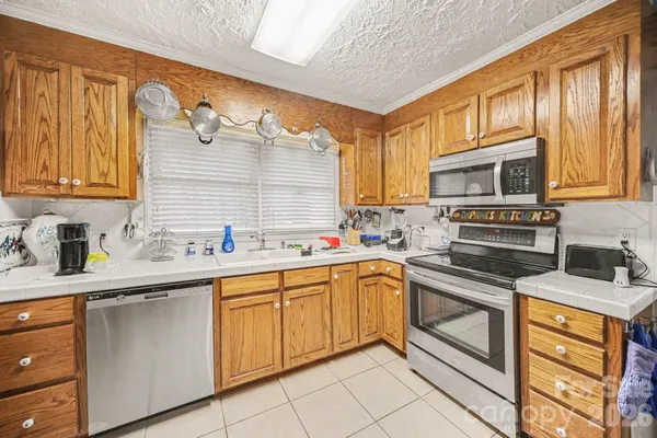 a kitchen with stainless steel appliances granite countertop a sink and cabinets