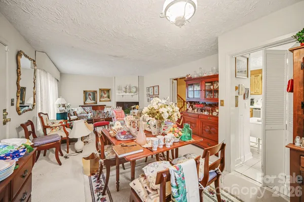 a very nice looking living room with dining room and furniture