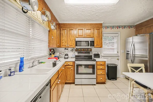 a kitchen with stainless steel appliances a stove sink and cabinets
