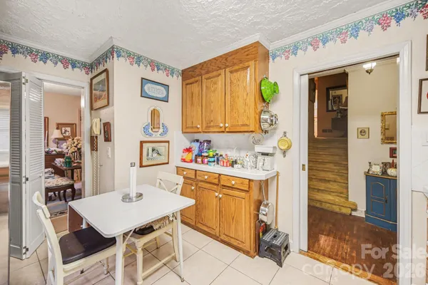 a view of a kitchen area with furniture and wooden floor