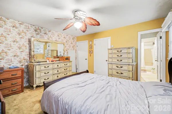 a bedroom with a bed and dresser