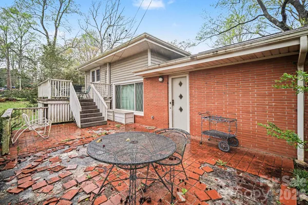 front view of a house with a chairs and table in the patio
