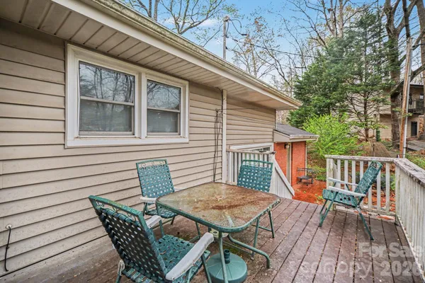 a view of deck with a table and chairs