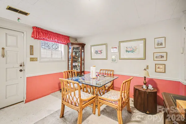 a dining room with furniture and window