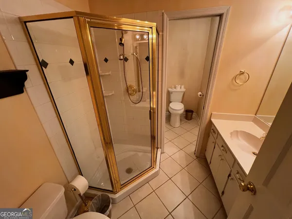 a bathroom with a sink a shower a mirror and a shower