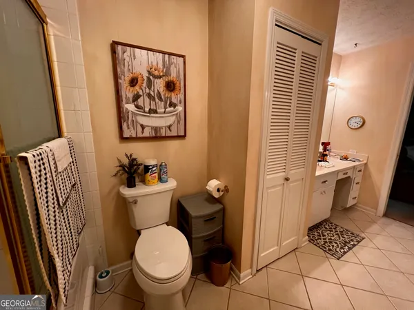 a bathroom with a toilet a sink and a mirror