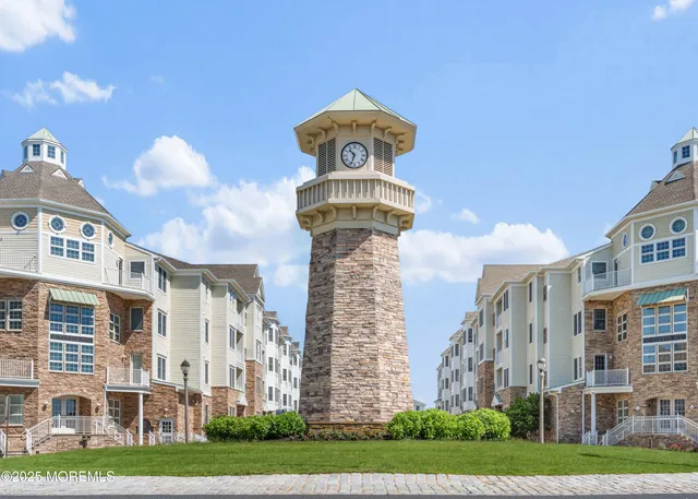 a front view of a building with a garden and plants