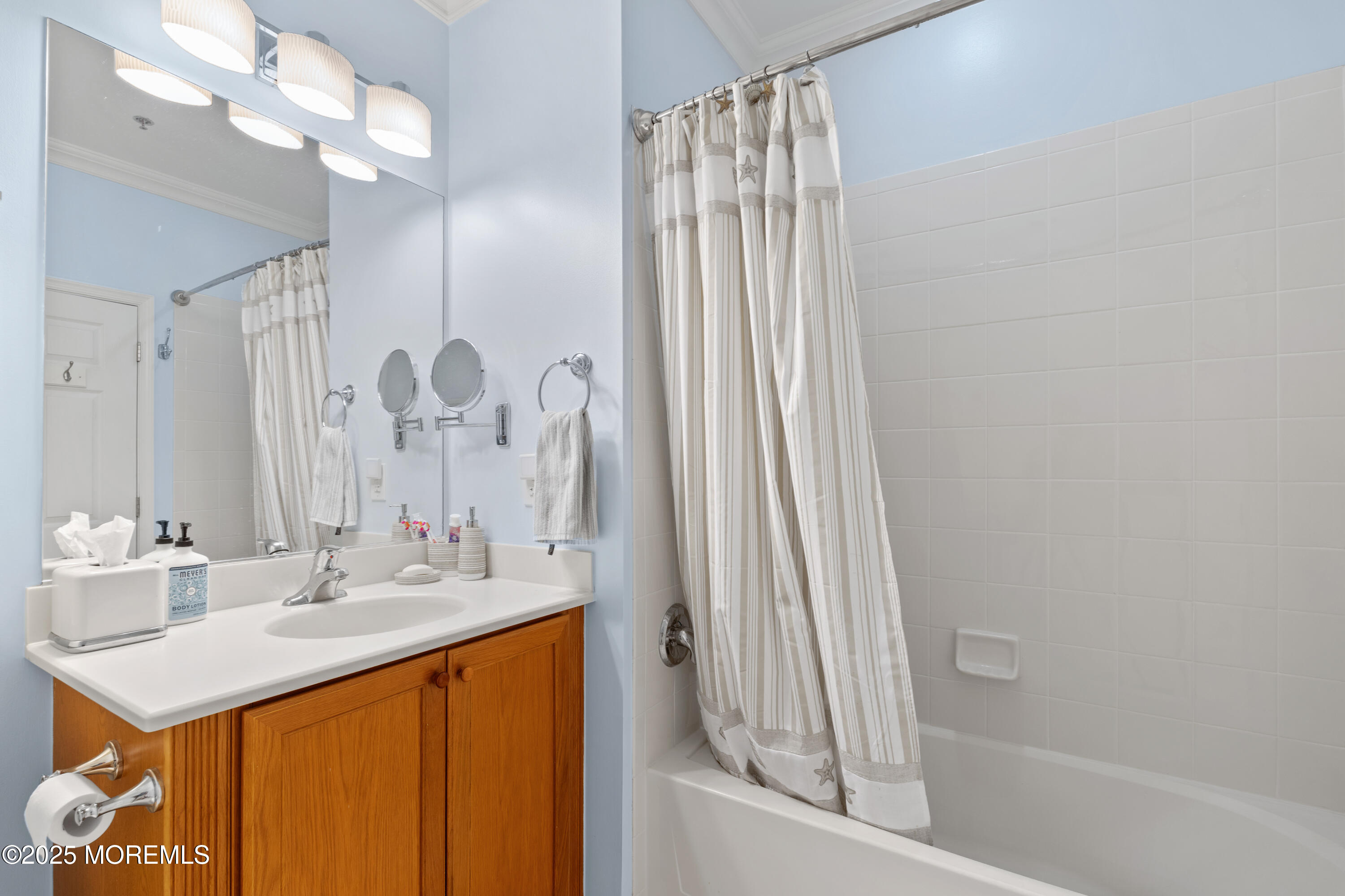 33 Cooper Avenue, Unit 208 Long Branch, NJ 07740 - Photo 21 of 43 a bathroom with a sink a mirror and a bathtub
