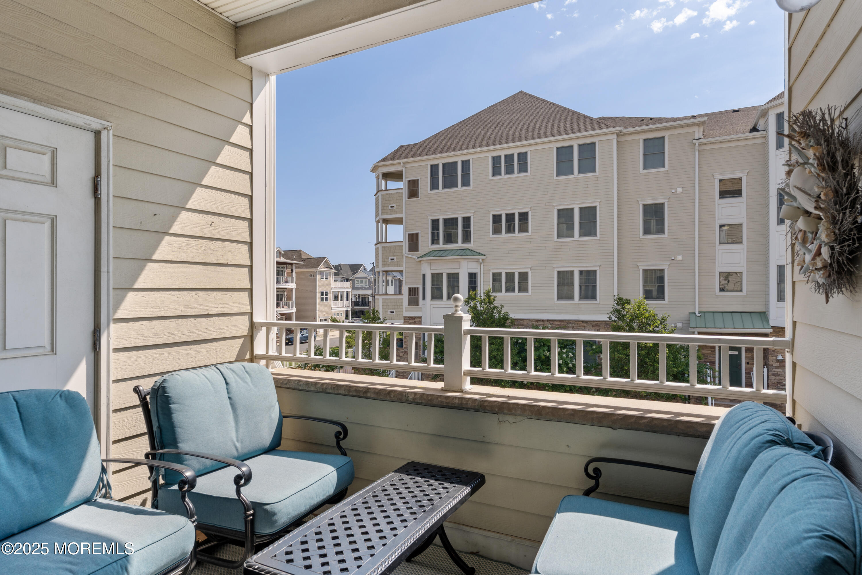 33 Cooper Avenue, Unit 208 Long Branch, NJ 07740 - Photo 24 of 43 a balcony with table and chairs