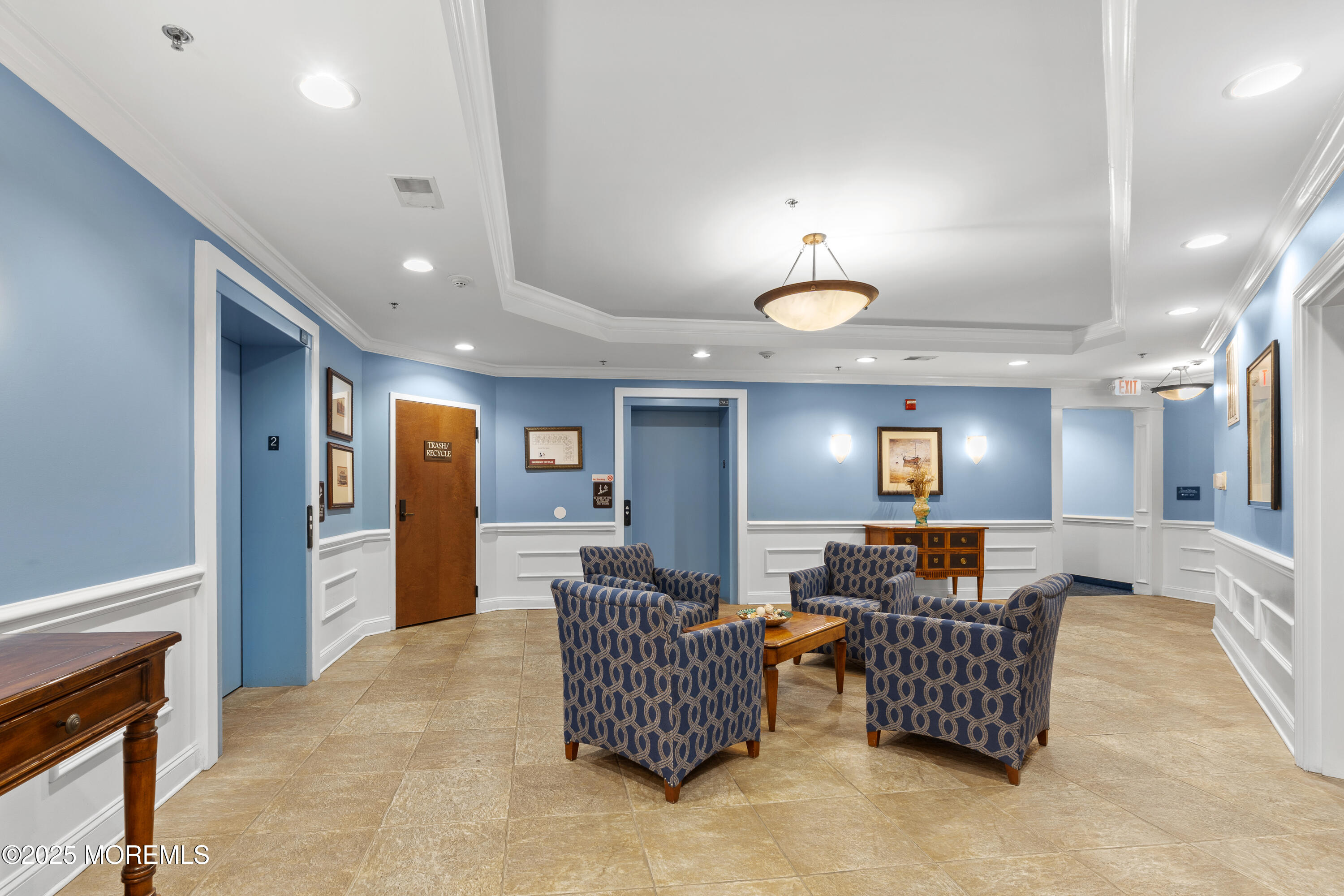 33 Cooper Avenue, Unit 208 Long Branch, NJ 07740 - Photo 27 of 43 a living room with furniture and a chandelier