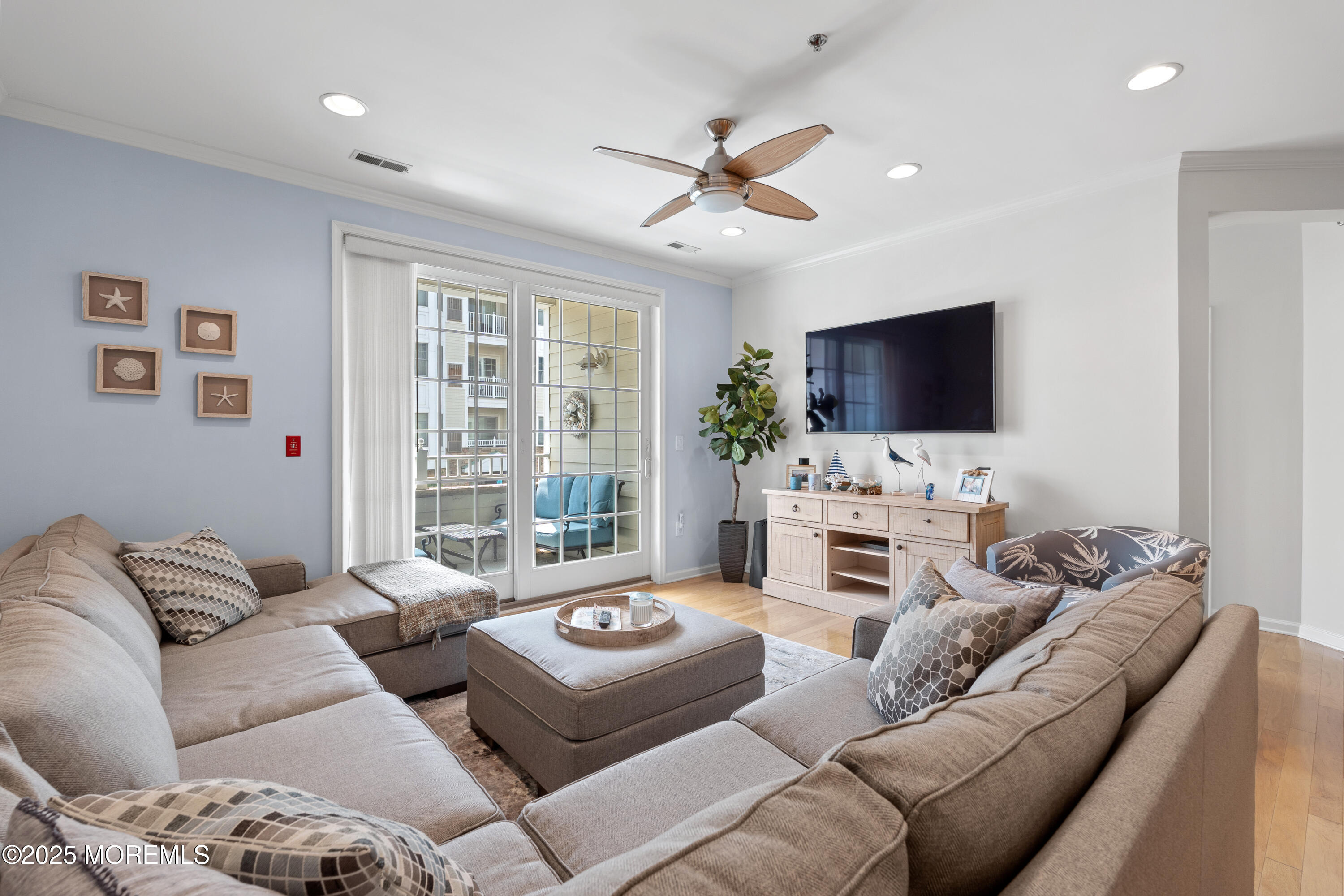 33 Cooper Avenue, Unit 208 Long Branch, NJ 07740 - Photo 6 of 43 a living room with furniture and a flat screen tv