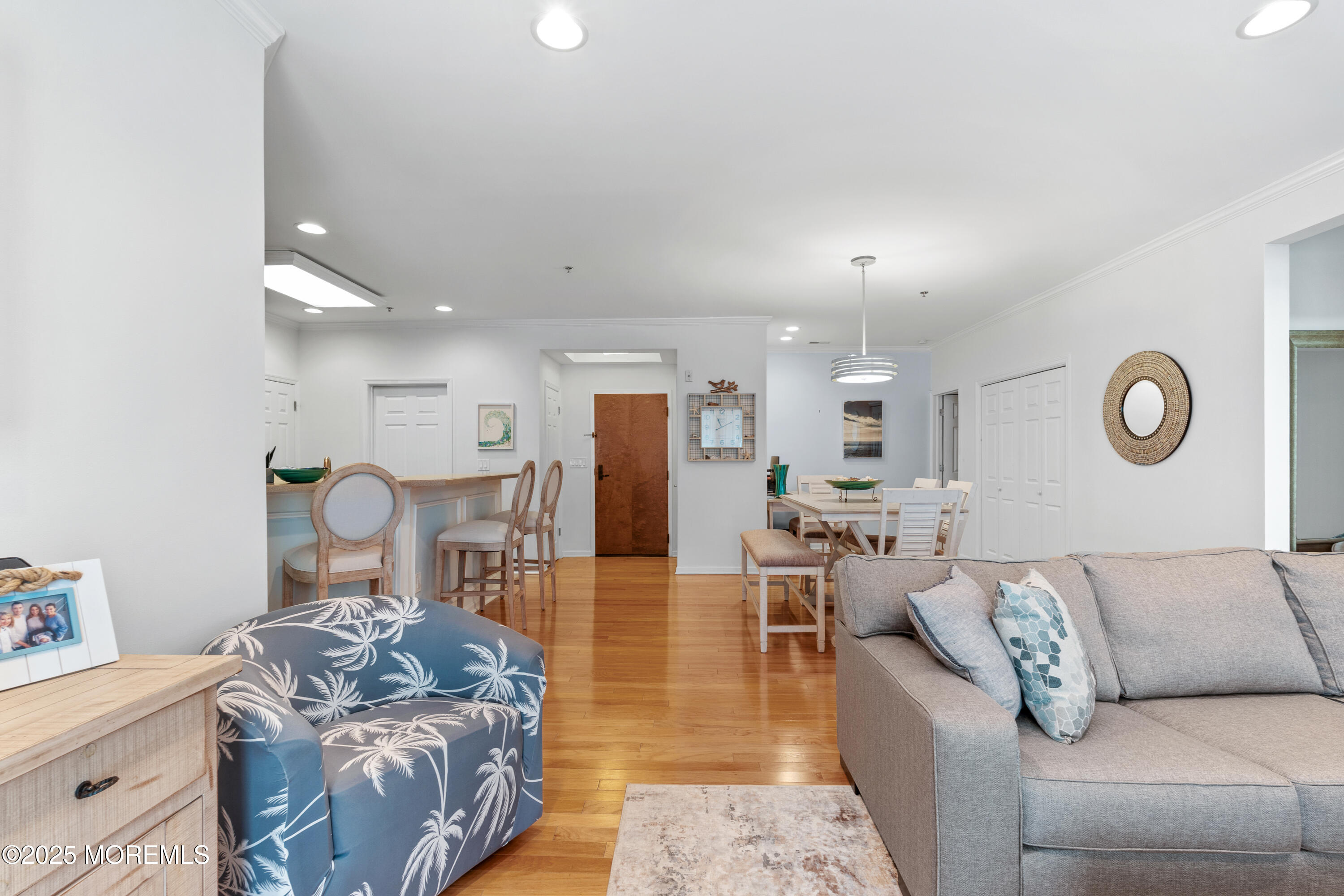 33 Cooper Avenue, Unit 208 Long Branch, NJ 07740 - Photo 42 of 43 a living room with furniture and a chandelier
