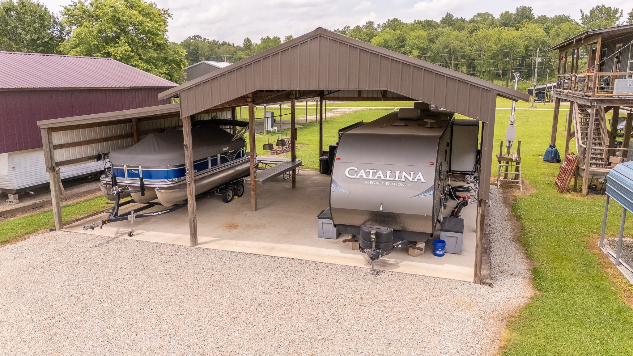 1038 WC PICKETT Road Clifton, TN 38425 - Photo 21 of 22 a view of a patio with a table and chairs under an umbrella
