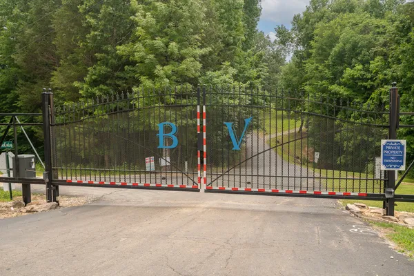 a view of a park with iron fence