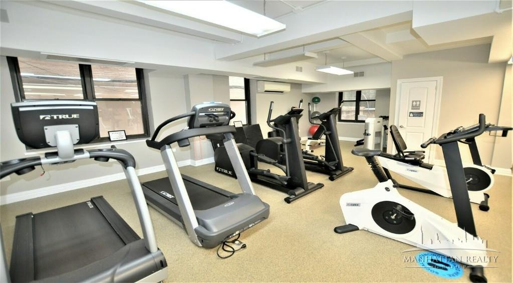 141 East 56th Street, Unit 4K Manhattan, NY 10022 - Photo 2 of 4 a view of a room with gym equipment