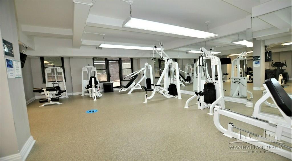 141 East 56th Street, Unit 4K Manhattan, NY 10022 - Photo 3 of 4 a view of a room with gym equipment