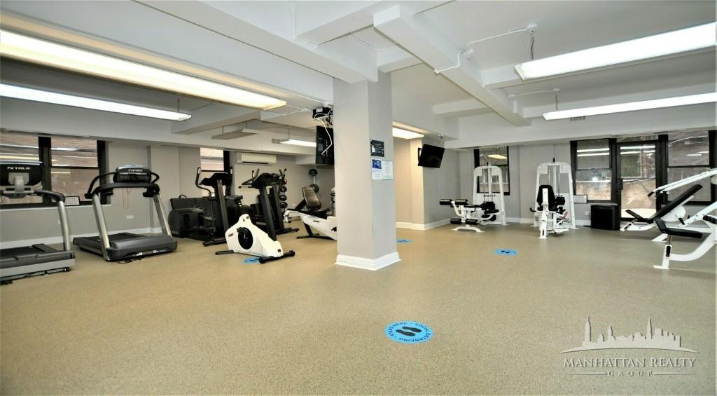 141 East 56th Street, Unit 4K Manhattan, NY 10022 - Photo 4 of 4 a view of a room with gym equipment