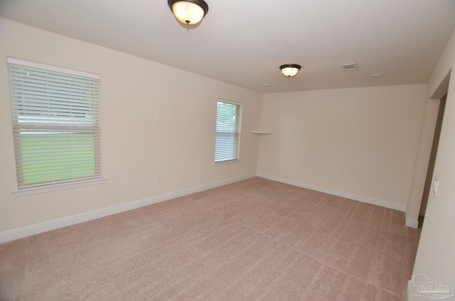 5709 Mill Stream Way Pace, FL 32571 - Photo 29 of 48 an empty room with windows