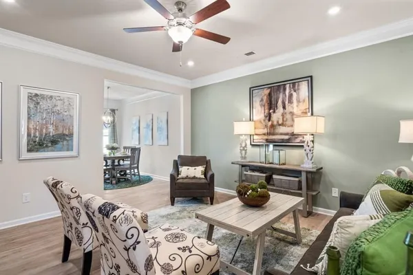 a living room with furniture and wooden floor