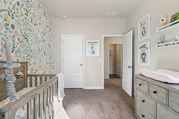 a view of a hallway with closet and wooden floor