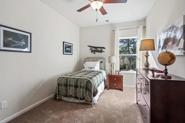a bedroom with a bed and window