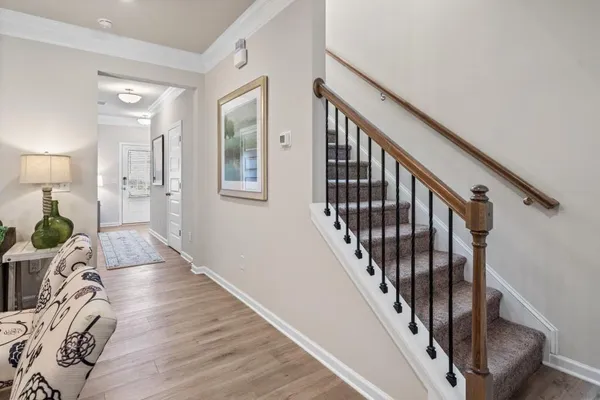 a view of entryway and hall with wooden floor