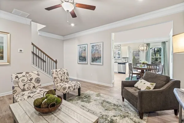 a living room with furniture and wooden floor
