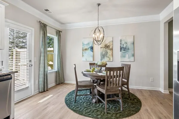 a view of a dining room with furniture window and wooden floor
