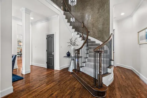 a view of entryway and hall with wooden floor