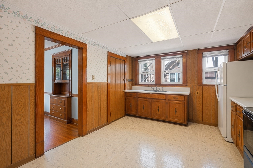 157 Elm Street Somerville, MA 02144 - Photo 8 of 19 a kitchen with a refrigerator and a stove